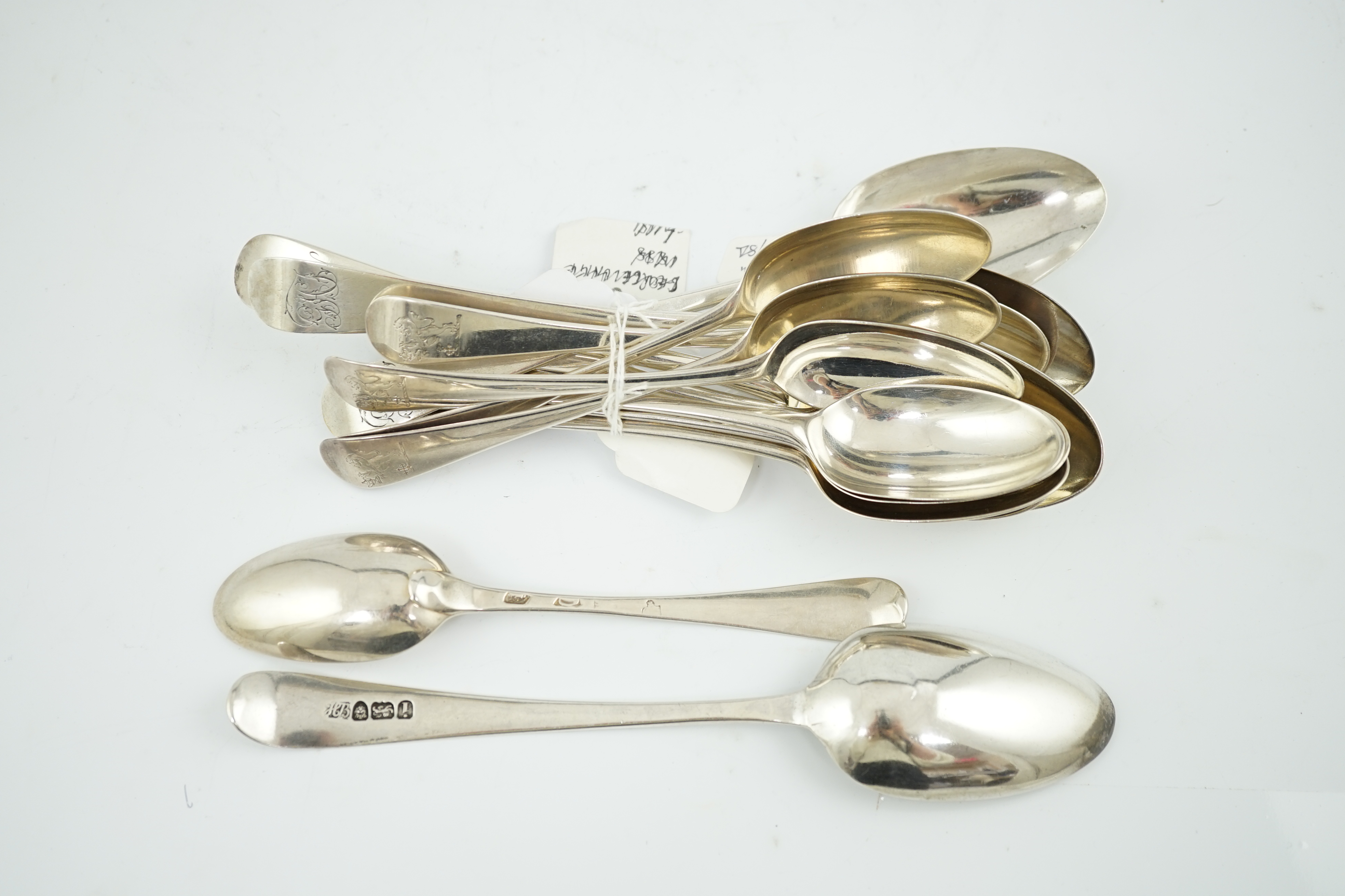 A set of nine George II silver Old English pattern dessert spoons, by George Hodges, London, 1731, together with four later spoons by Hester Bateman